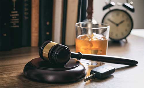 Drunk driving symbolism: A gavel, a phone and an alcoholic drink