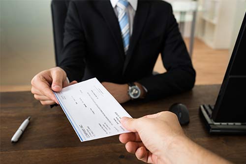 handing a settlement check to a client