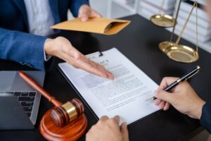 Legal counsel presenting a signed contract to the client in an office. Justice and lawyer concept.