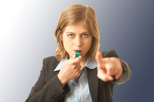 woman blowing a whistle and pointing a finger